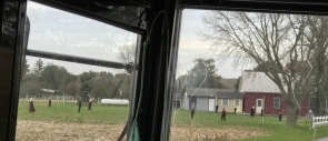Amish children playing baseball at recess.